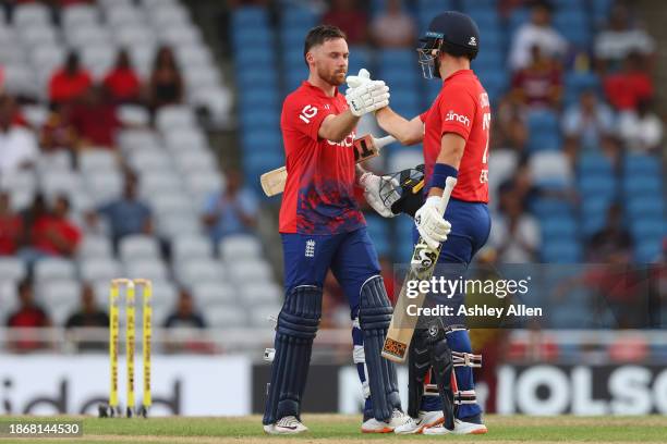 Liam Livingstone congratulates his teammate Phil Salt of England on reaching his century during the 4th T20 International match between West Indies...