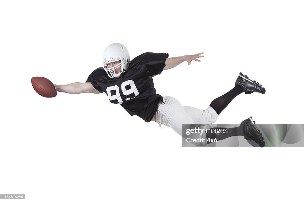 American football player catching a ball