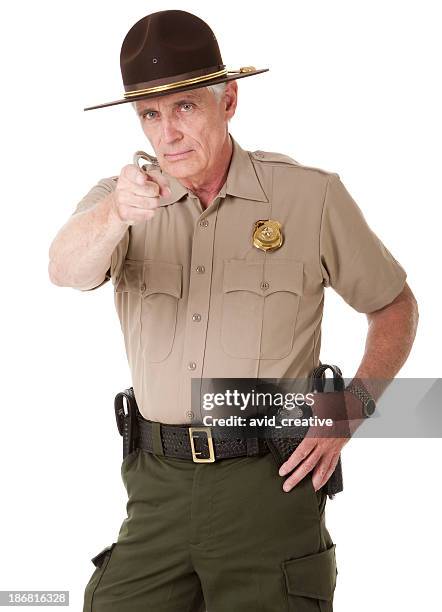 mature highway patrolman pointing - highway patrol stock pictures, royalty-free photos & images