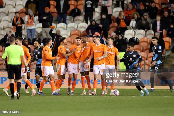 Marvin Ekpiteta of Blackpool celebrates with team mates after scoring their sides third goal during the Emirates FA Cup Second Round match between...