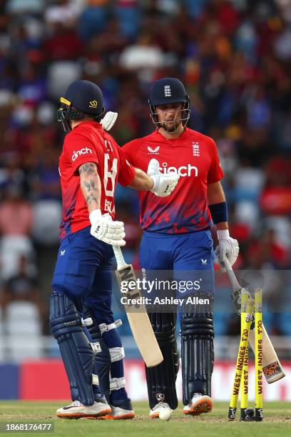 Liam Livingstone of England congratulates teammate Phil Salt on his innings of 119 during the 4th T20 International match between West Indies and...