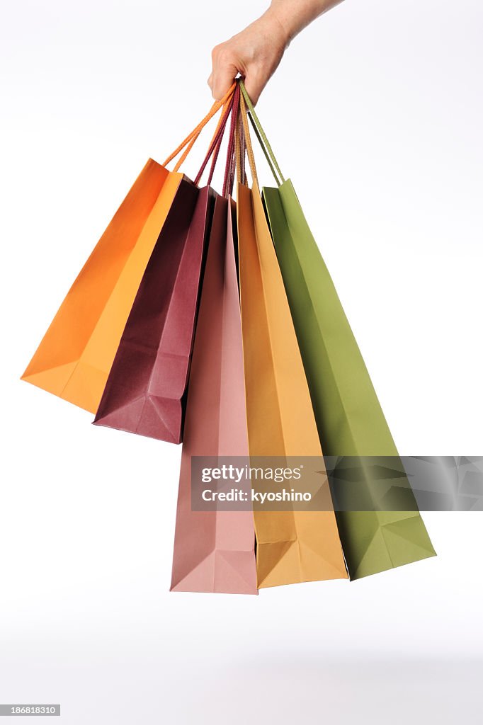 Isolated shot of hand carrying shopping bags against white background