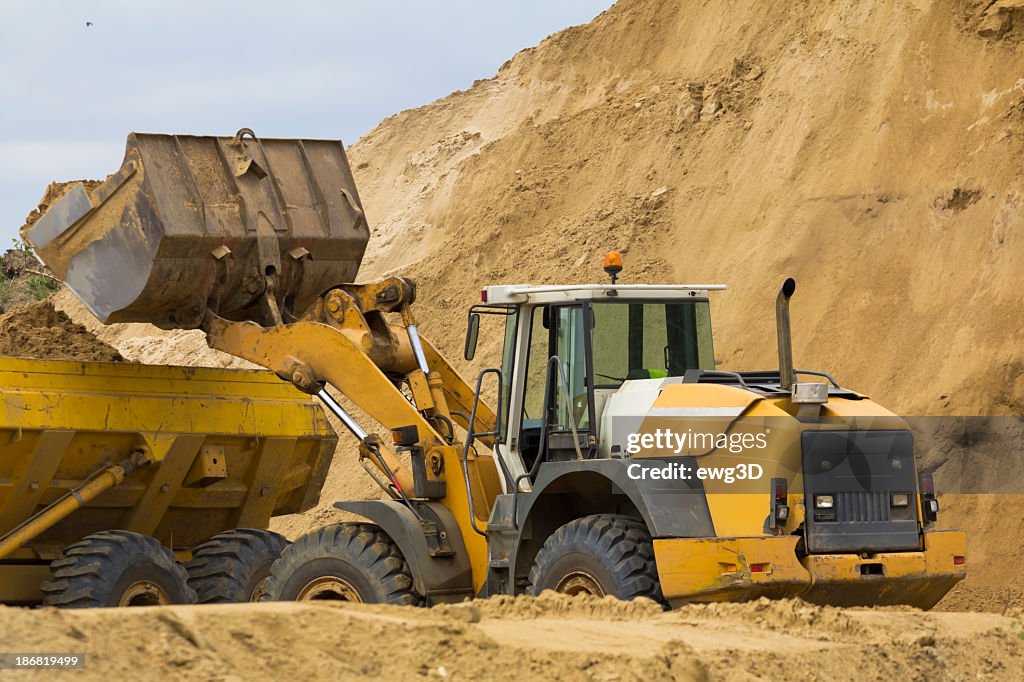Earth Mover loading ground to the dump truck