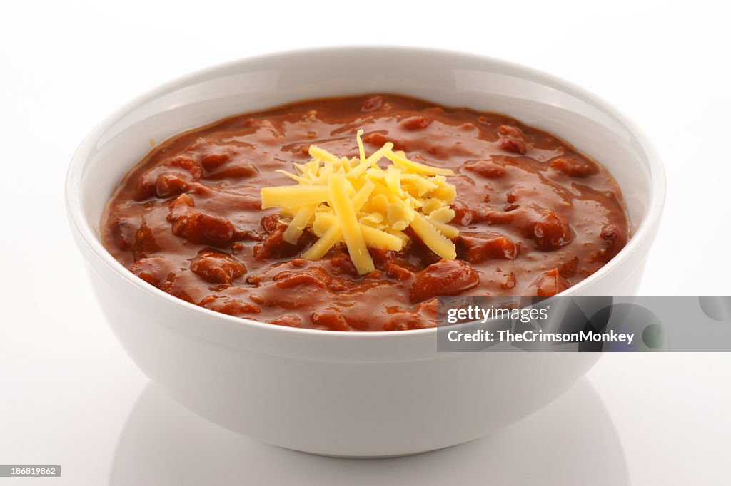 Bowl full of chili beans topped with cheddar cheese