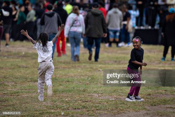 Los Angeles, CA Children enjoy a festive day at Nickerson Gardens housing projects as they wait for Top Dawg Entertainment's 10th annual toy drive...