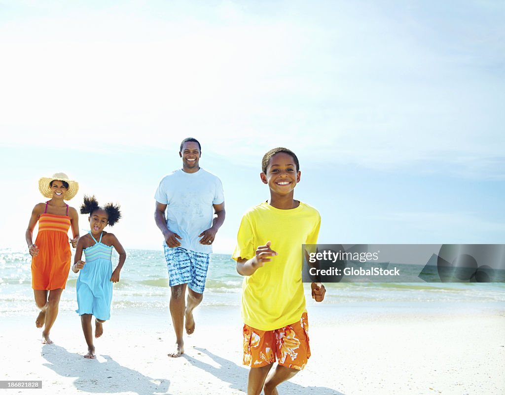 Family running together on the beach