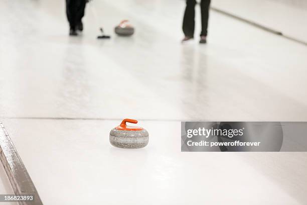 sweeping the curling stone - curling sport stock pictures, royalty-free photos & images