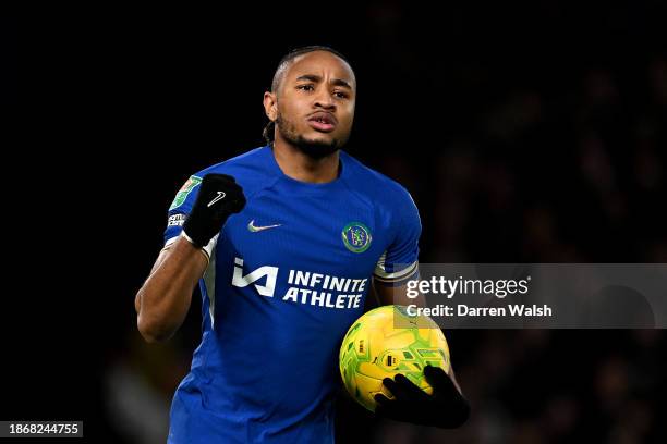 Christopher Nkunku of Chelsea celebrates after scoring their sides third penalty during the Carabao Cup Quarter Final match between Chelsea and...