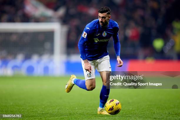 Diego Rico of Getafe CF runs with the ball during the LaLiga EA Sports match between Atletico Madrid and Getafe CF at Civitas Metropolitano Stadium...