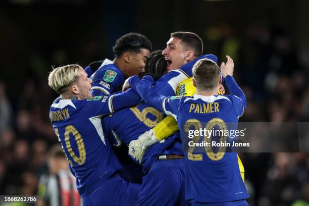 Keeper Djordje Petrovic of Chelsea celebrates with team-mates after he saves Matt Ritchie of Newcastle United penalty to win the shoot-out after a...