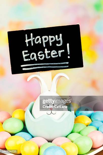 easter bunny with sign - easter candy stock pictures, royalty-free photos & images