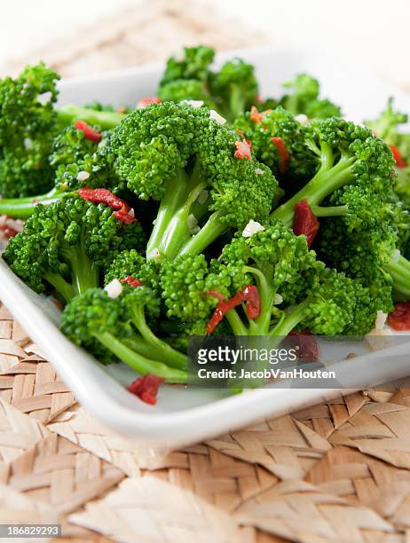 broccoli with sun-dried tomatoes - plate side view stock pictures, royalty-free photos & images