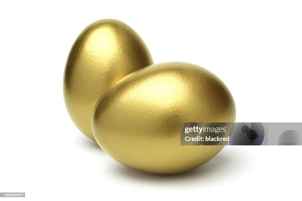 Two Golden Eggs on White Background
