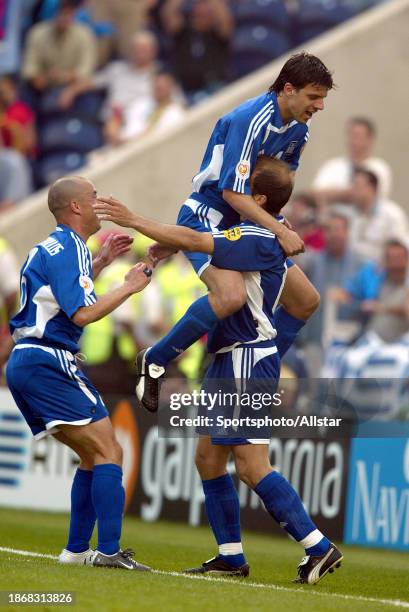 June 12: Angelos Basinas and Takis Fyssas of Greece celebrate during the UEFA Euro 2004 match between Portugal and Greece at Estadio Do Dragao on...