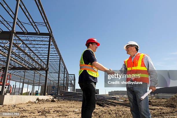 construction, blueprints and handshake - handshake site stock pictures, royalty-free photos & images