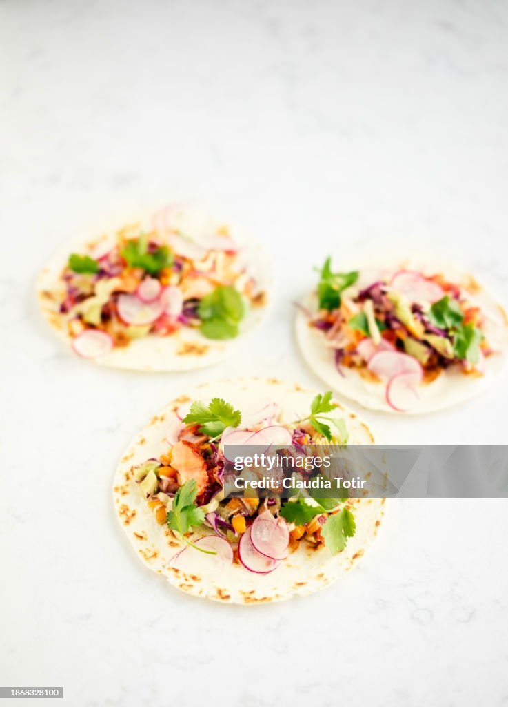 Fish (salmon) tacos on white background