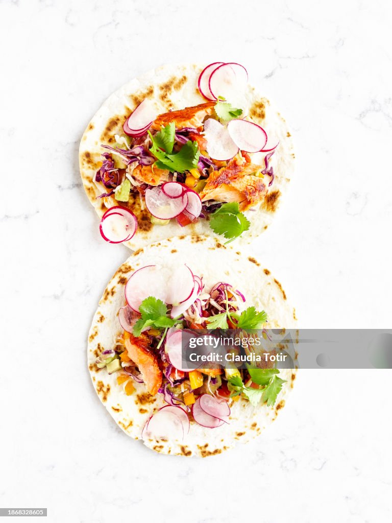 Fish (salmon) tacos on white background