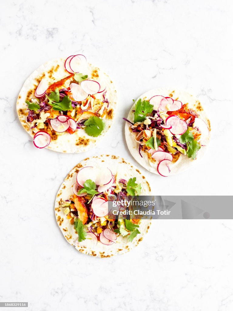 Fish (salmon) tacos on white background