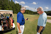 Golfers checking GPS rangefinder
