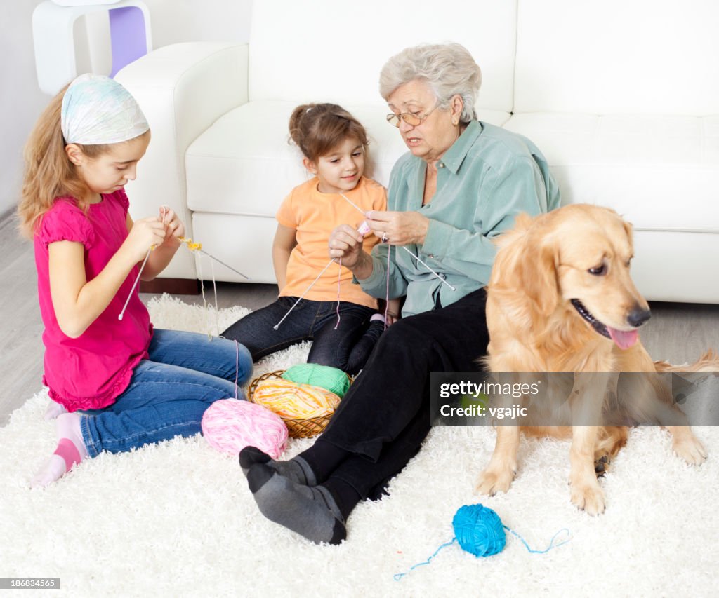 Grandmother and grandchildren knitting at home