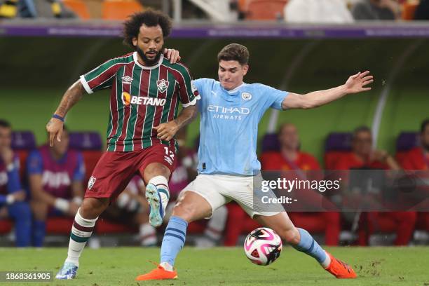 Manchester City's Argentine forward Julian Alvarez fights for the ball with Fluminense's Brazilian defender Marcelo during the FIFA Club World Cup...