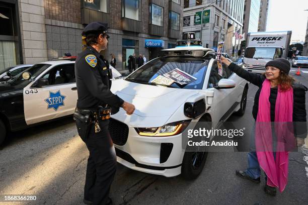 Waymo autonomous taxi stuck during a ''Free Palestine'' demonstration organized by Code Pink Activists outside of Israeli Consulate on a busy street...