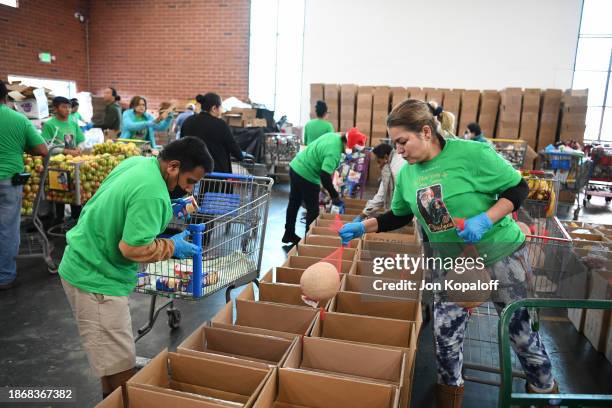 Volunteers participate as Feeding America hosts Holiday Volunteer Opportunity at North Valley Caring Services on December 22, 2023 in North Hills,...