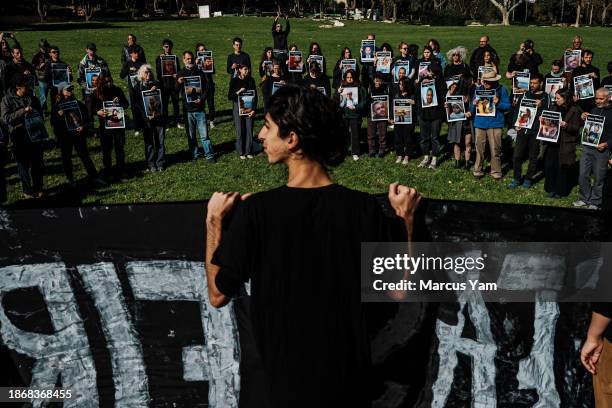 Activists attend a vigil to mourn more than 20,000 Palestinians killed in Gaza and to call for an immediate ceasefire to end the cycle of violence in...