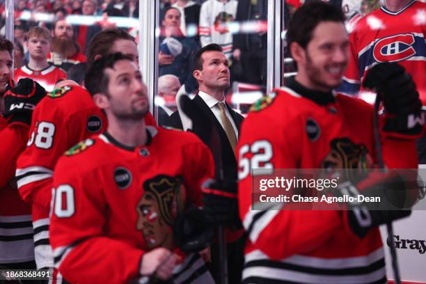 Head coach Luke Richardson of the Chicago Blackhawks stands for the national anthem prior to the game against the Montreal Canadiens at the United...