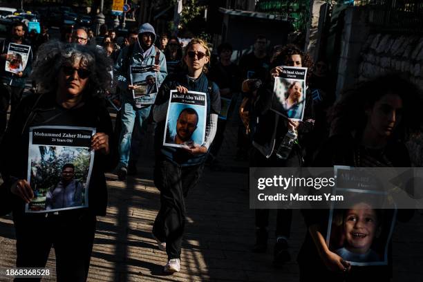 Activists attend a vigil to mourn more than 20,000 Palestinians killed in Gaza and to call for an immediate ceasefire to end the cycle of violence in...