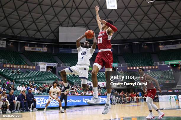 Imo Essien of the Old Dominion Monarchs attempts to shoot over Steve Settle III of the Temple Owls during the second half of their game in the...