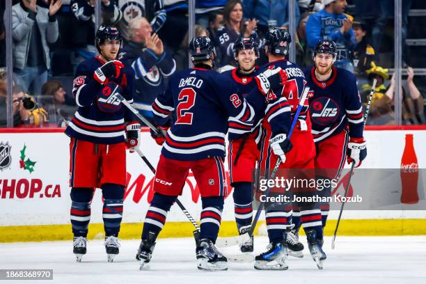 Mark Scheifele, Dylan DeMelo, Nikolaj Ehlers, Josh Morrissey and Gabriel Vilardi of the Winnipeg Jets celebrate a first period goal against the...