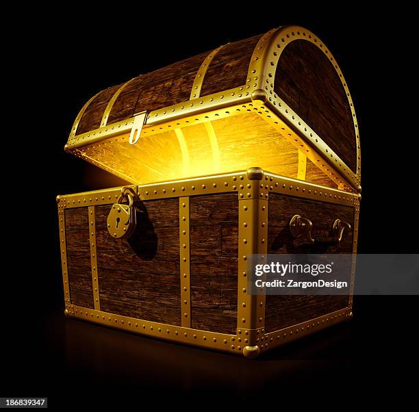 a treasure chest with a glowing light - schatkist stockfoto's en -beelden