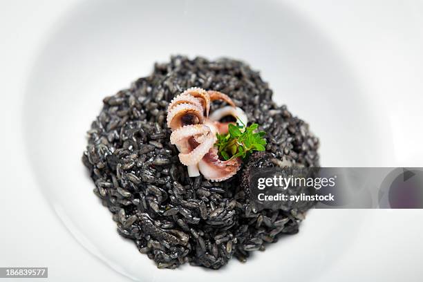 octopus with black rice - arroz negro - arroz negro stock pictures, royalty-free photos & images