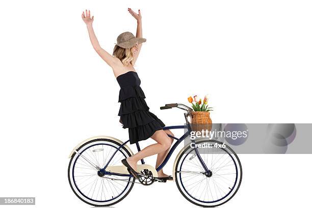 woman cycling without holding the handlebars - hands free cycling stock pictures, royalty-free photos & images