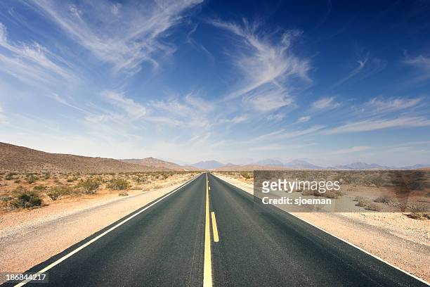 journey ahead - desert road stock pictures, royalty-free photos & images