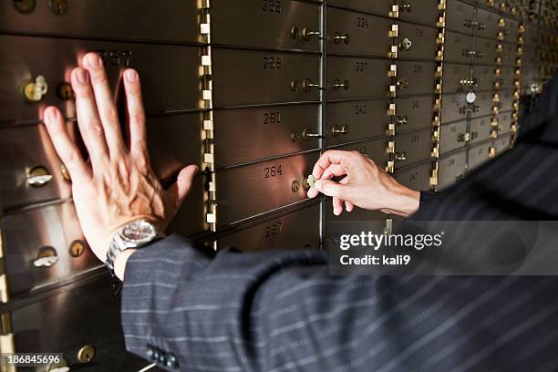 man opening safety deposit box - safety deposit box stock pictures, royalty-free photos & images