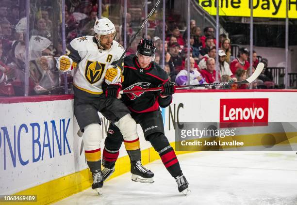 Andrei Svechnikov of the Carolina Hurricanes hits Alex Pietrangelo of the Vegas Golden Knights during the first period at PNC Arena on December 19,...