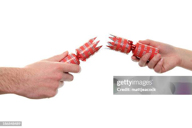 pulling a cracker - christmas cracker stock pictures, royalty-free photos & images