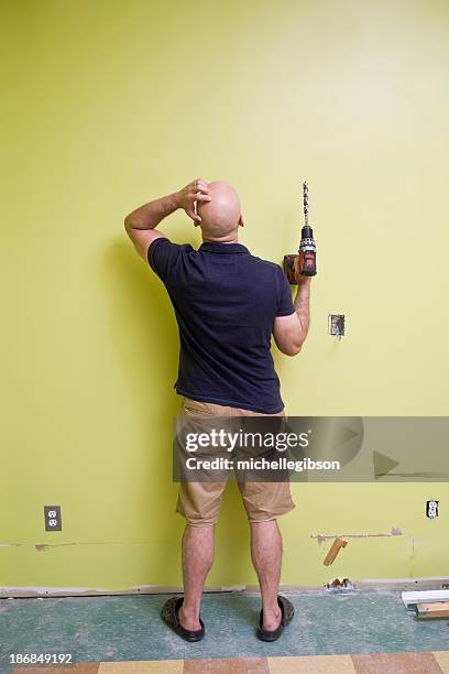 man with a power drill doing home repairs - frustrated workman stock pictures, royalty-free photos & images