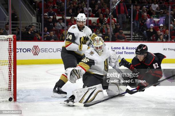 Logan Thompson of the Vegas Golden Knights makes a save against Jesperi Kotkaniemi of the Carolina Hurricanes during the second period of the game at...