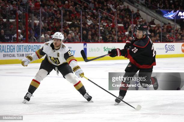 Sebastian Aho of the Carolina Hurricanes attempts a shot against Jack Eichel of the Vegas Golden Knights during the second period of the game at PNC...