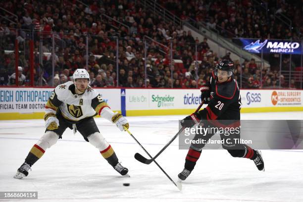 Sebastian Aho of the Carolina Hurricanes attempts a shot against Jack Eichel of the Vegas Golden Knights during the second period of the game at PNC...