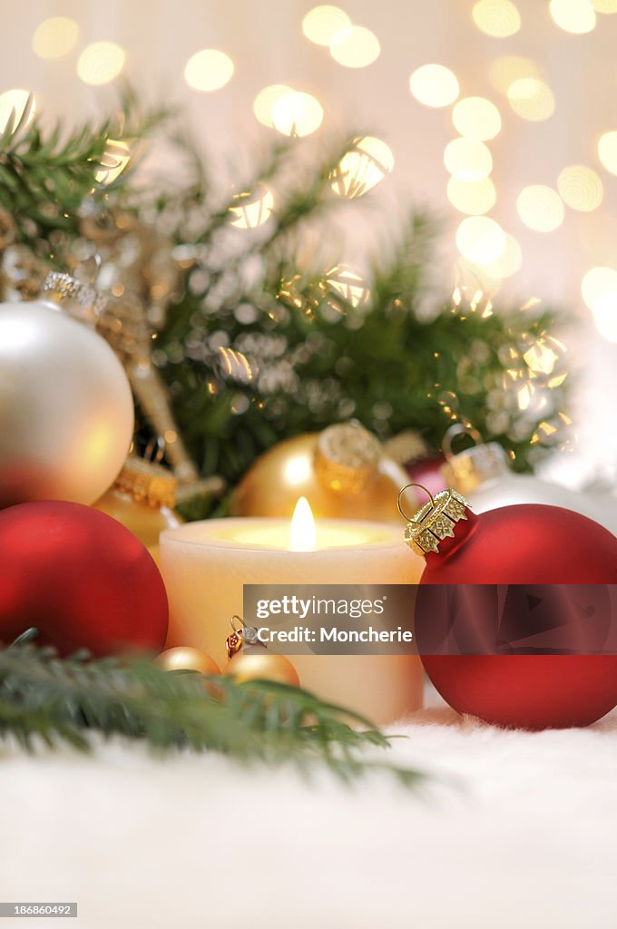 Candle with christmas balls and pine tree