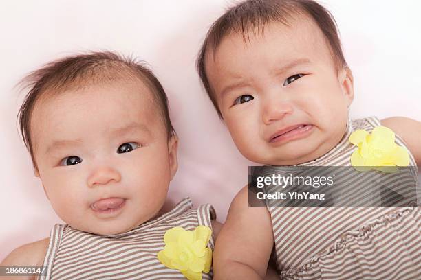 asian twin baby girls, chinese infants happy, sad, cheerful, crying - asian twins 個照片及圖片檔