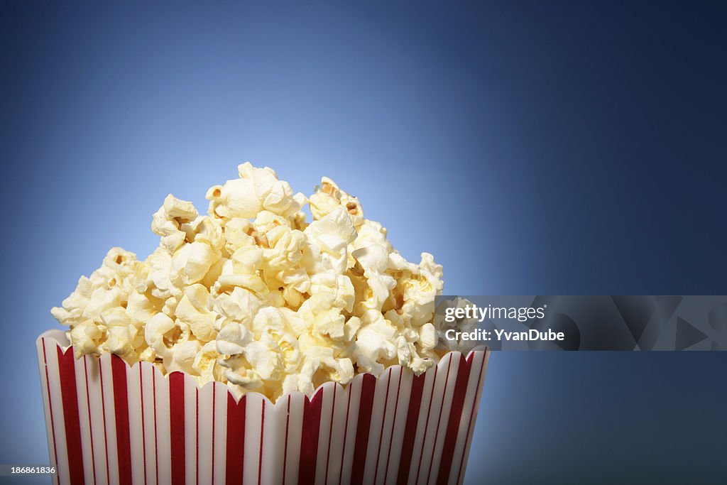 Red movie popcorn box with blue background