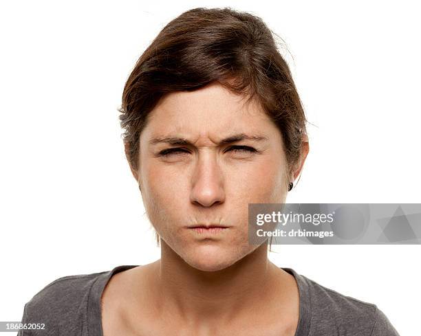 tough frowning young woman close up portrait - squinting stock pictures, royalty-free photos & images