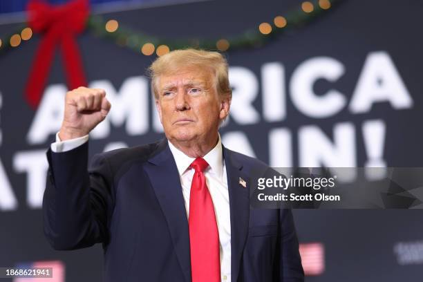 Republican presidential candidate and former U.S. President Donald Trump gestures as he wraps up a campaign event on December 19, 2023 in Waterloo,...