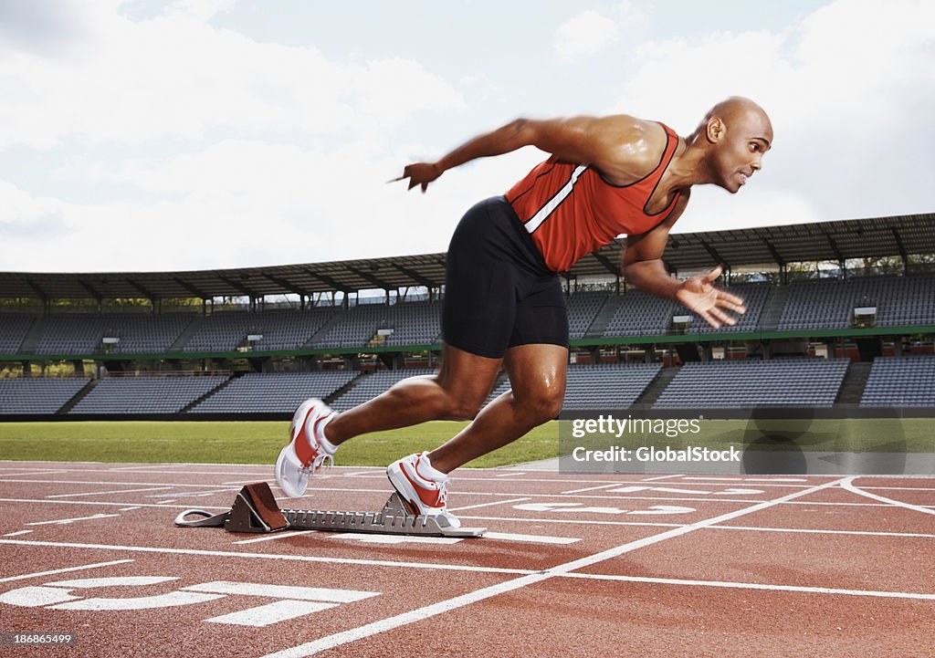 Male athlete on the starting line of running track