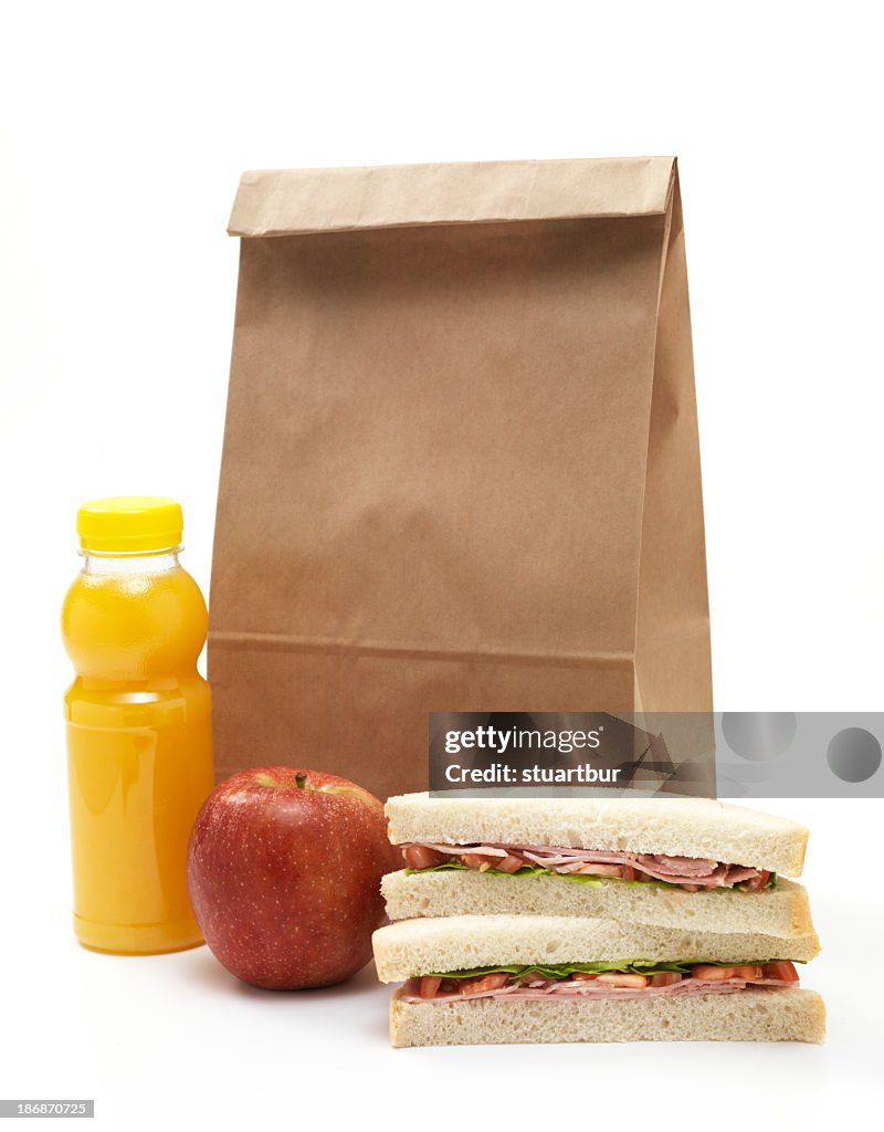 Lunch bag with sandwich, apple and orange juice